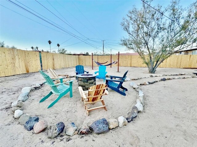 view of yard featuring an outdoor fire pit