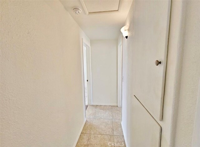 hallway featuring light tile patterned floors