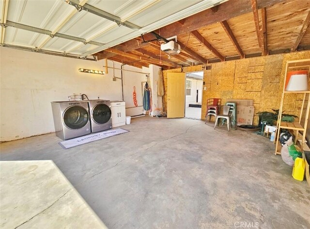 garage featuring a garage door opener and washing machine and clothes dryer