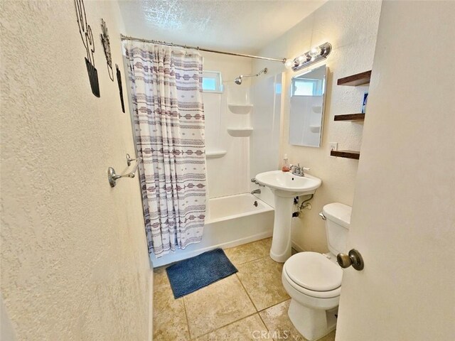 bathroom featuring toilet, shower / tub combo, and tile patterned floors