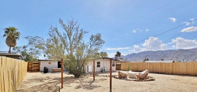 back of property featuring an outbuilding and a mountain view