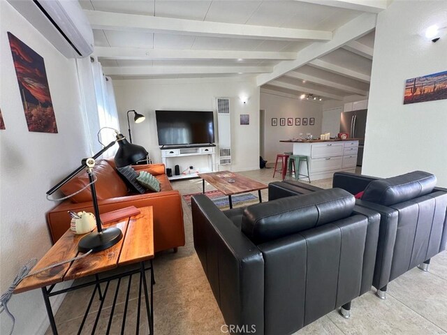 living room featuring lofted ceiling with beams and an AC wall unit