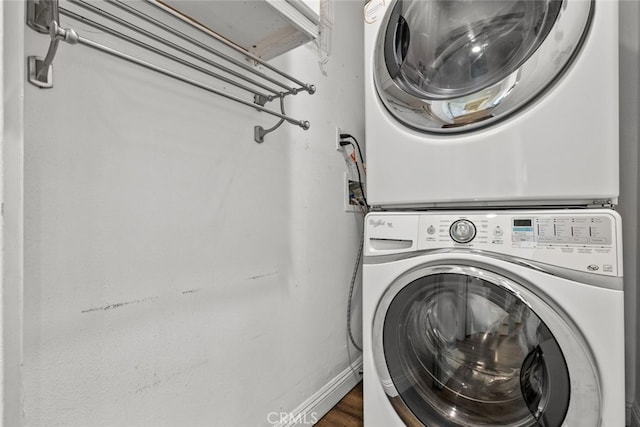 washroom featuring stacked washer and clothes dryer