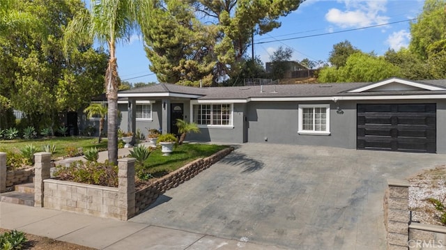 ranch-style house featuring a front yard and a garage