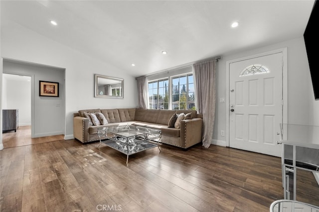 living room with dark hardwood / wood-style flooring and lofted ceiling