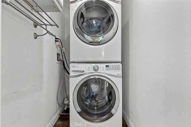 laundry room featuring stacked washer / drying machine