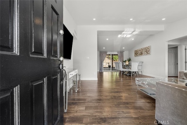 foyer featuring dark hardwood / wood-style flooring and lofted ceiling