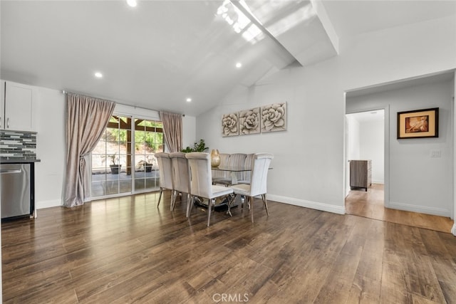 dining space featuring dark wood-type flooring and vaulted ceiling