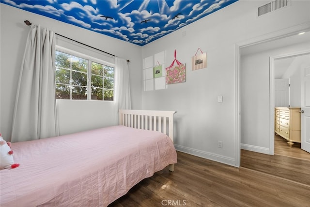 bedroom featuring dark hardwood / wood-style flooring