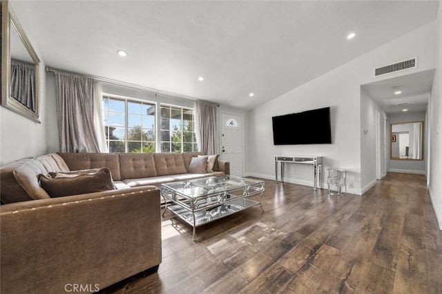 living room featuring dark hardwood / wood-style floors and vaulted ceiling