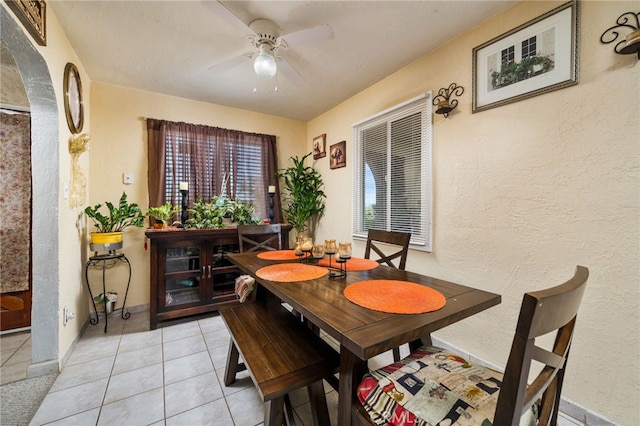 tiled dining room featuring ceiling fan