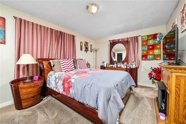 bedroom with a textured ceiling and carpet flooring