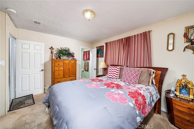 carpeted bedroom with a textured ceiling