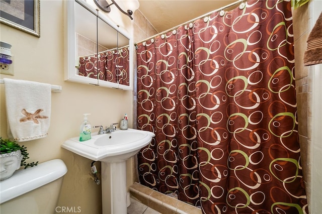 bathroom with toilet and curtained shower