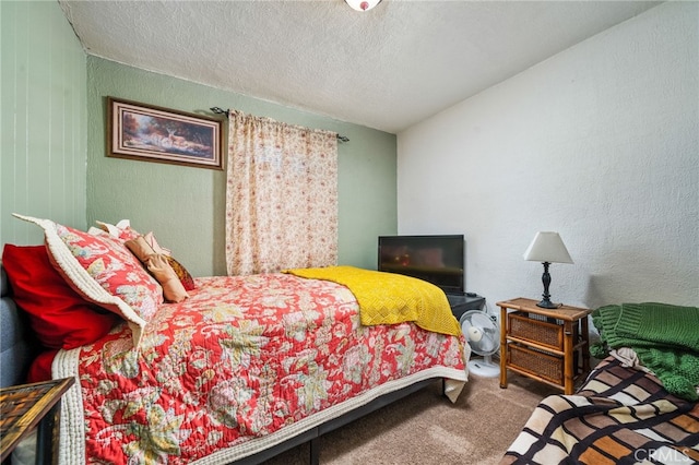 bedroom with a textured ceiling and carpet