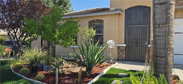 doorway to property with a garage