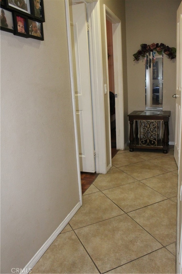 hall with light tile patterned floors