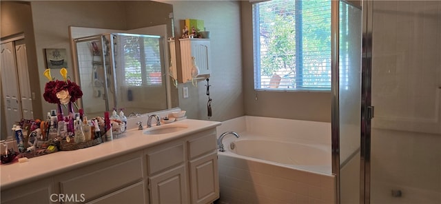 bathroom featuring plus walk in shower, plenty of natural light, and vanity