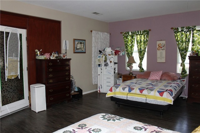 bedroom with dark hardwood / wood-style floors