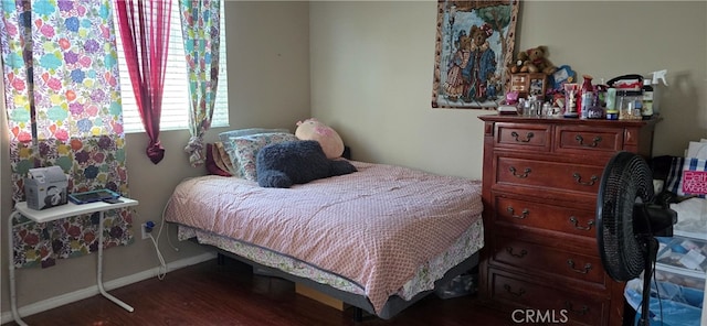 bedroom with dark wood-type flooring