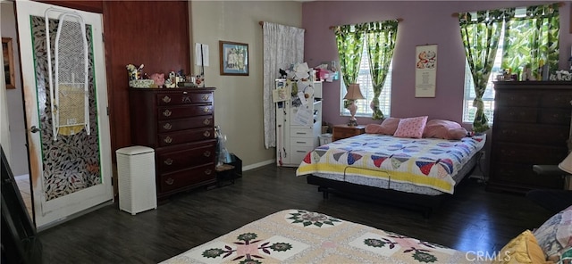 bedroom featuring dark wood-type flooring and multiple windows