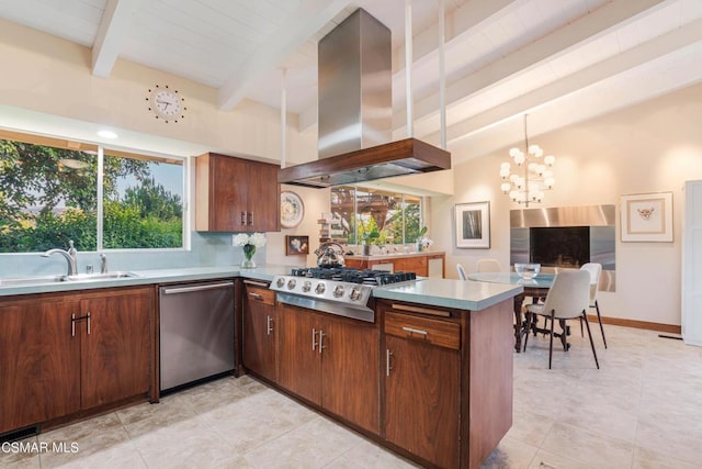 kitchen featuring sink, hanging light fixtures, island exhaust hood, kitchen peninsula, and stainless steel appliances