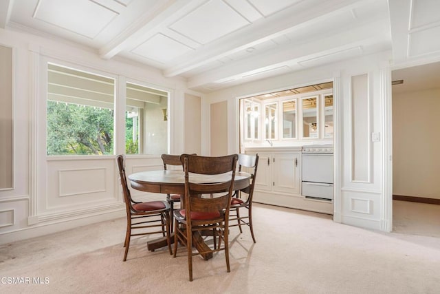 dining space featuring beamed ceiling, light colored carpet, and sink