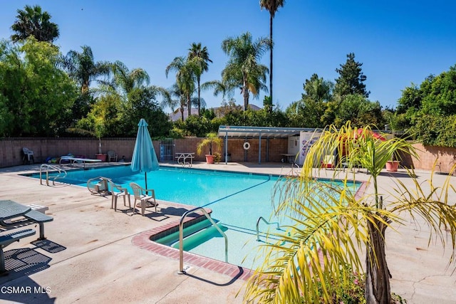 view of swimming pool featuring a patio area