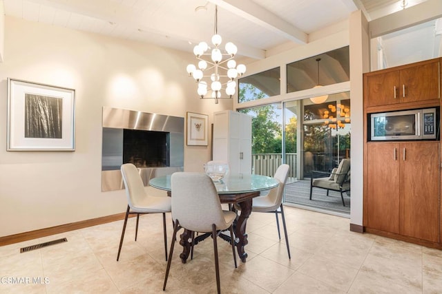 dining space featuring an inviting chandelier, beam ceiling, and light tile patterned floors