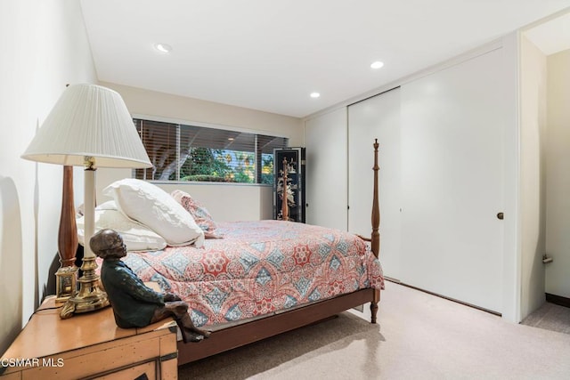 bedroom with light colored carpet and a closet