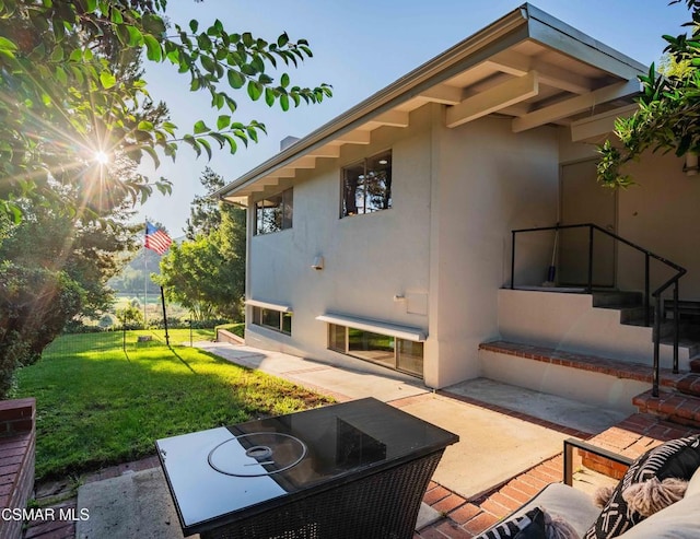 exterior space featuring a yard and a patio