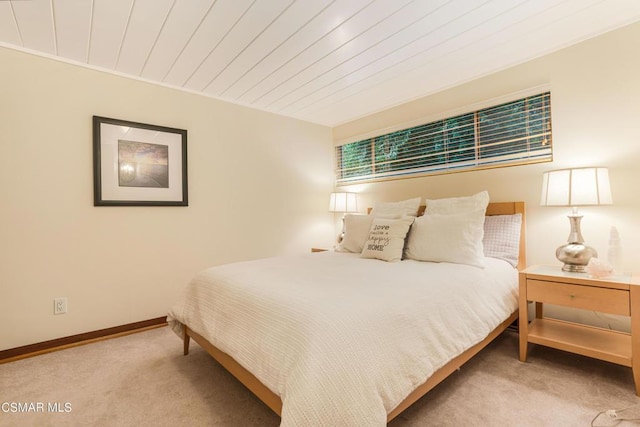 bedroom with wood ceiling and carpet