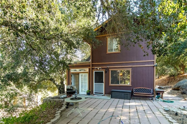 back of property with a patio area and a balcony