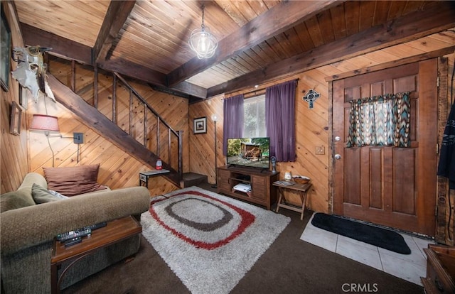 living room featuring tile patterned flooring, wood ceiling, beam ceiling, and wood walls