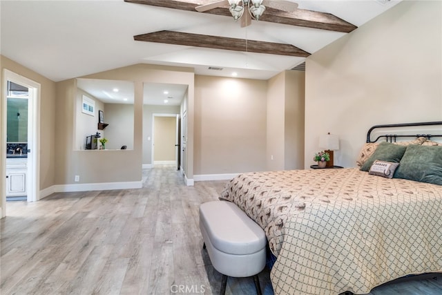 bedroom with ceiling fan, vaulted ceiling with beams, connected bathroom, sink, and light hardwood / wood-style floors