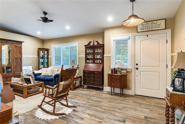 living room with light wood-type flooring and ceiling fan