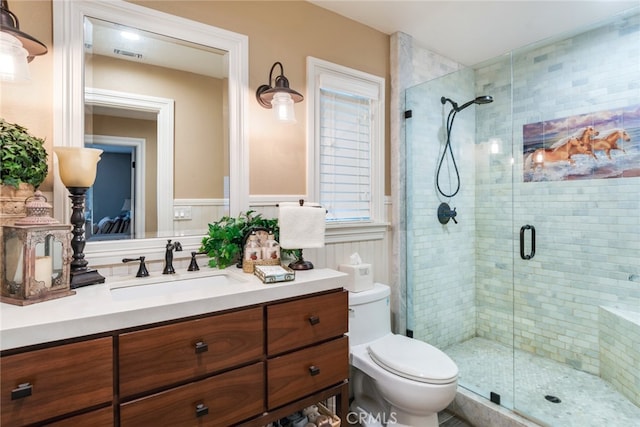 bathroom with vanity, toilet, and an enclosed shower