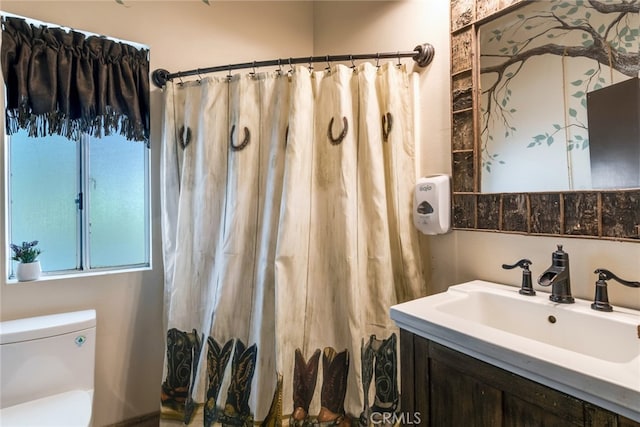 bathroom with walk in shower, vanity, and toilet