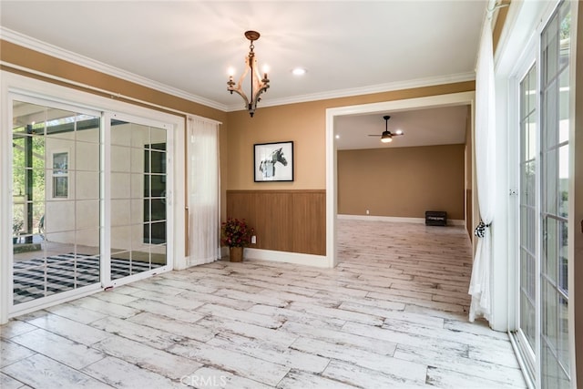 spare room featuring light hardwood / wood-style flooring, a chandelier, and ornamental molding