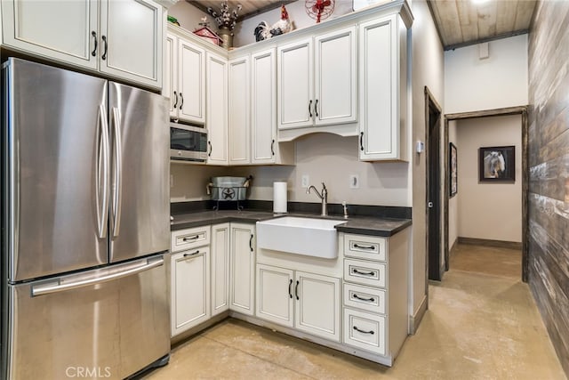 kitchen with stainless steel appliances, sink, wood ceiling, and white cabinetry