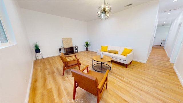 living room with hardwood / wood-style flooring and a chandelier