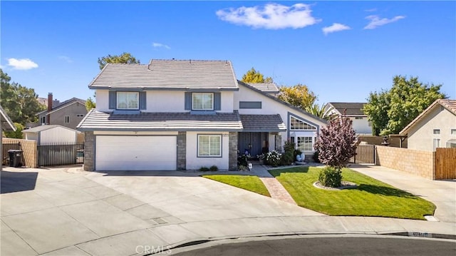 view of front property featuring a front lawn and a garage