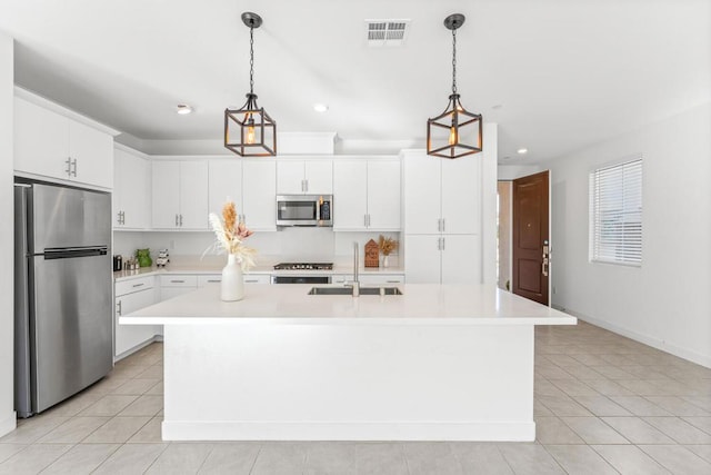 kitchen featuring white cabinetry, sink, a center island with sink, and appliances with stainless steel finishes