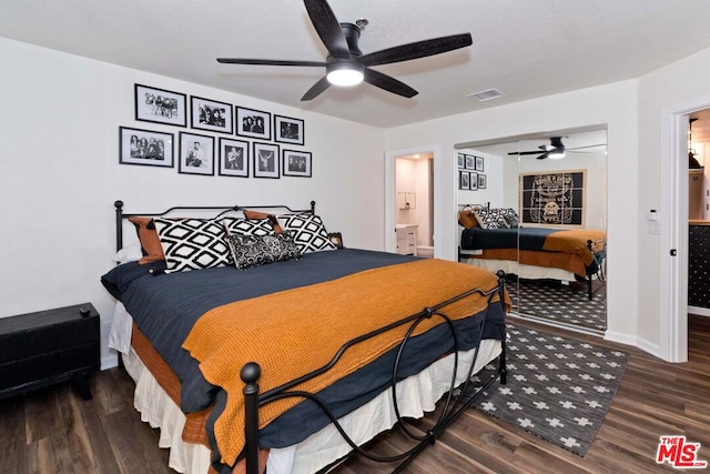 bedroom featuring ensuite bathroom, dark hardwood / wood-style flooring, and ceiling fan