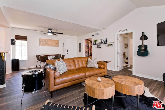 living room with ceiling fan, dark wood-type flooring, and vaulted ceiling