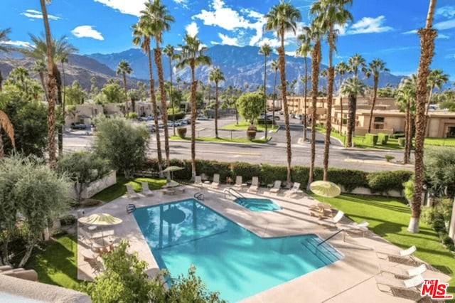 view of pool with a mountain view and a patio area