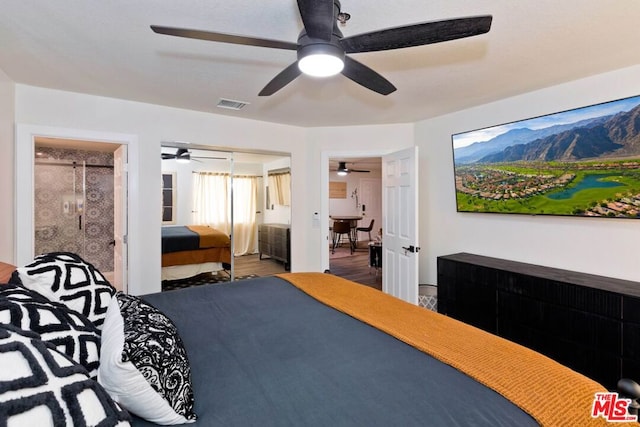 bedroom with hardwood / wood-style floors, a closet, ensuite bathroom, and ceiling fan