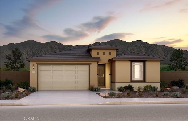 prairie-style house with a garage and a mountain view