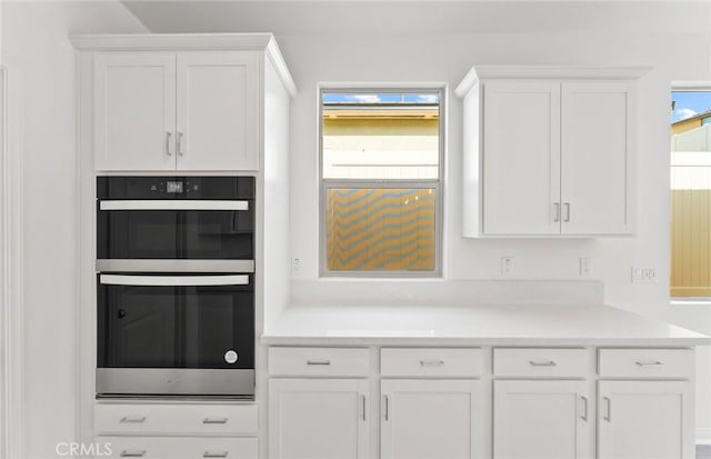 kitchen featuring white cabinets and double oven