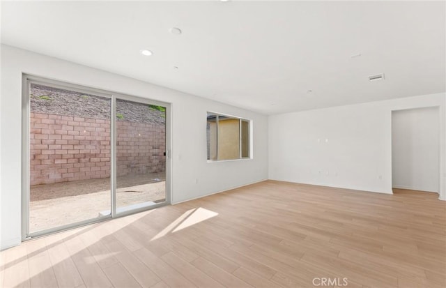 empty room featuring light hardwood / wood-style floors and a wealth of natural light